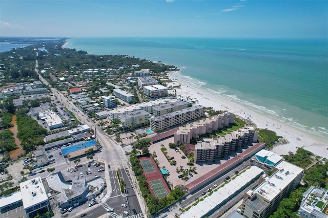 drone / aerial view featuring a water view and a beach view