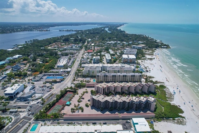 drone / aerial view with a beach view and a water view