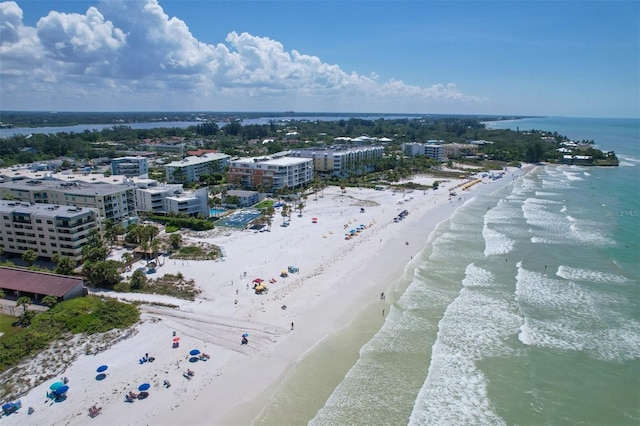 birds eye view of property with a view of the beach and a water view