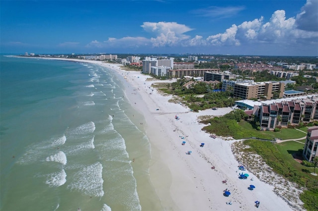 birds eye view of property with a water view and a beach view