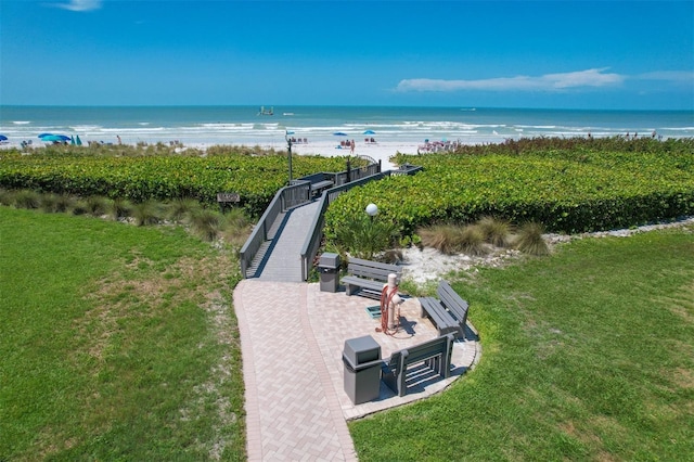 birds eye view of property with a view of the beach and a water view