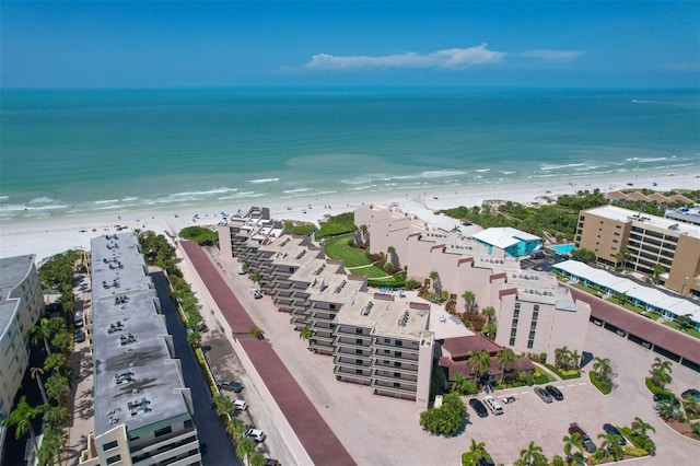 bird's eye view featuring a water view and a beach view