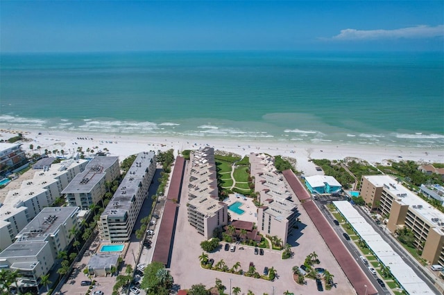 drone / aerial view featuring a water view and a view of the beach