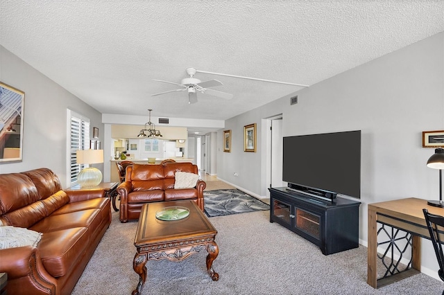 carpeted living room featuring a textured ceiling and ceiling fan