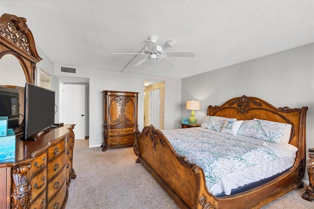 bedroom with light carpet, a textured ceiling, and ceiling fan