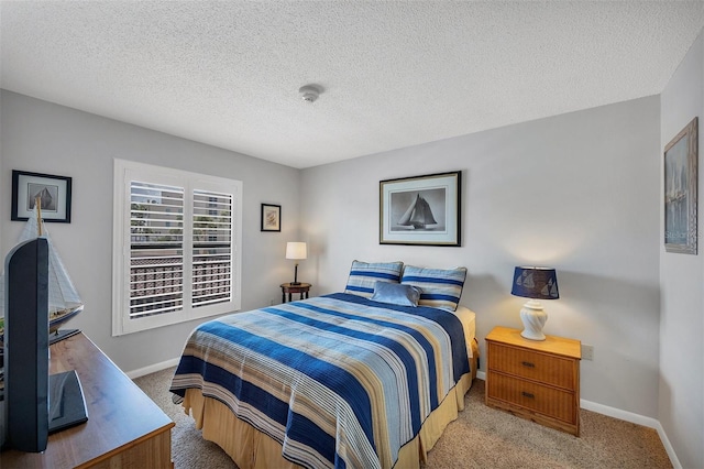 carpeted bedroom featuring a textured ceiling