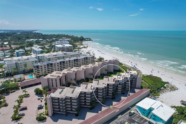 drone / aerial view with a beach view and a water view