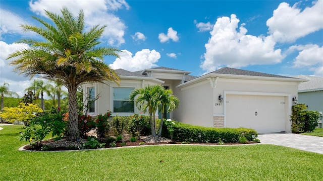 view of front of home with a garage and a front lawn