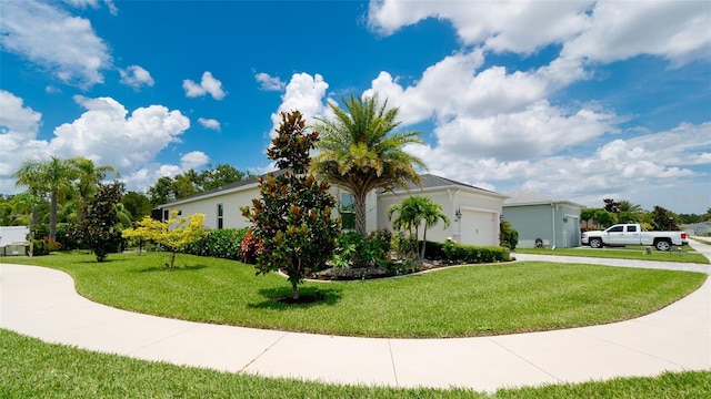 view of side of home with a yard and a garage