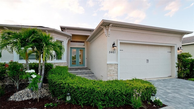 view of front of property with french doors and a garage