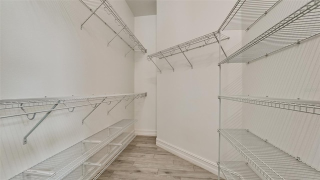 walk in closet featuring light hardwood / wood-style floors