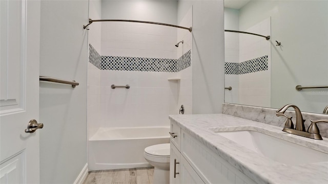 full bathroom featuring toilet, tiled shower / bath, vanity, and wood-type flooring