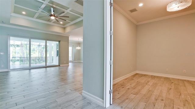 unfurnished room featuring light hardwood / wood-style flooring, ornamental molding, coffered ceiling, and ceiling fan with notable chandelier