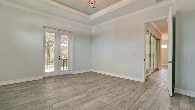 unfurnished room with french doors, light hardwood / wood-style floors, and ornamental molding