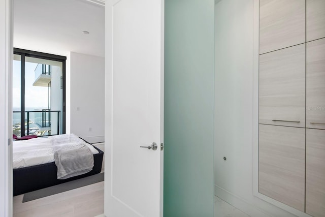 bathroom featuring expansive windows and hardwood / wood-style floors