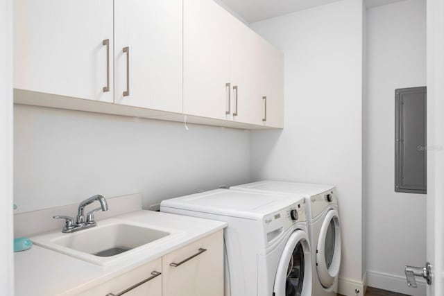 washroom with independent washer and dryer, cabinets, and sink