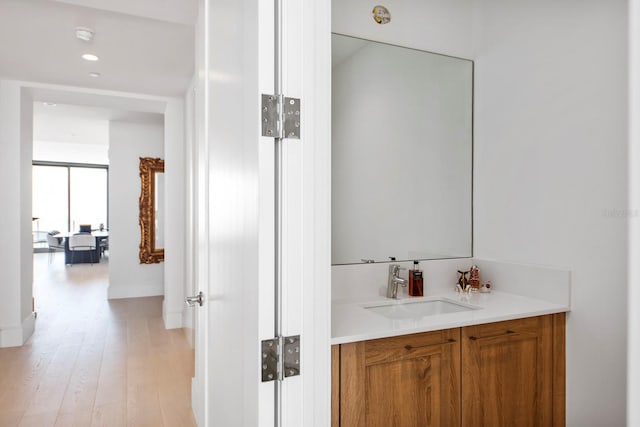 bathroom with hardwood / wood-style floors and vanity