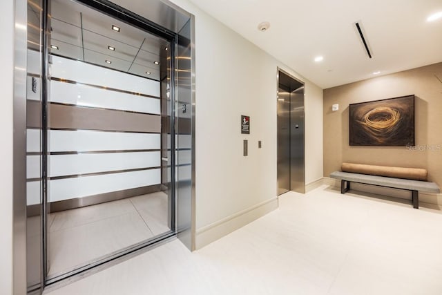 interior space featuring light tile floors and elevator