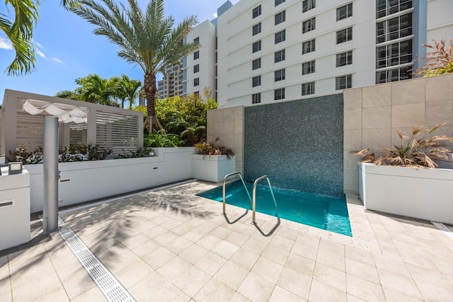 view of pool with a pergola and a patio