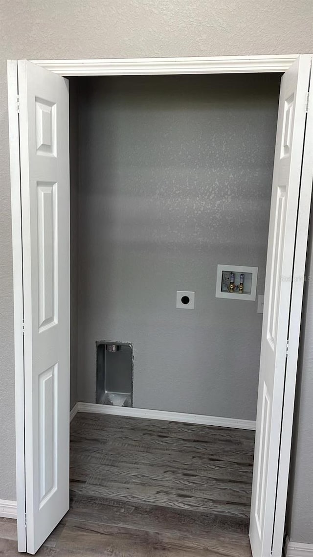 clothes washing area featuring a textured ceiling, hookup for a washing machine, hookup for an electric dryer, and dark hardwood / wood-style floors