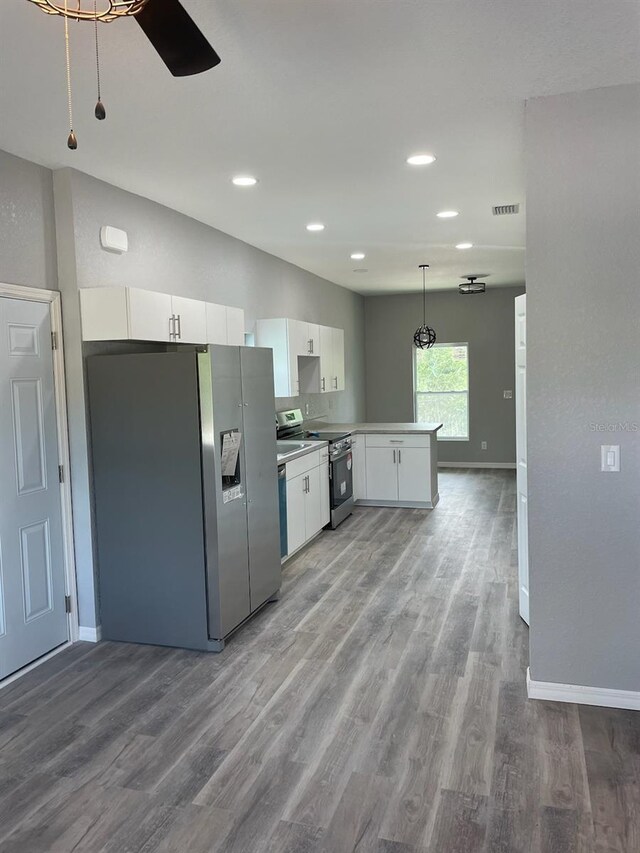 kitchen with white cabinetry, decorative light fixtures, stainless steel appliances, ceiling fan, and hardwood / wood-style flooring