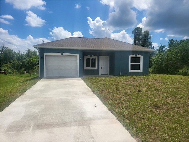 view of front of house with a front yard and a garage