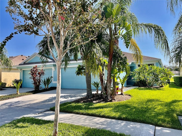 view of front of home with a front yard and a garage