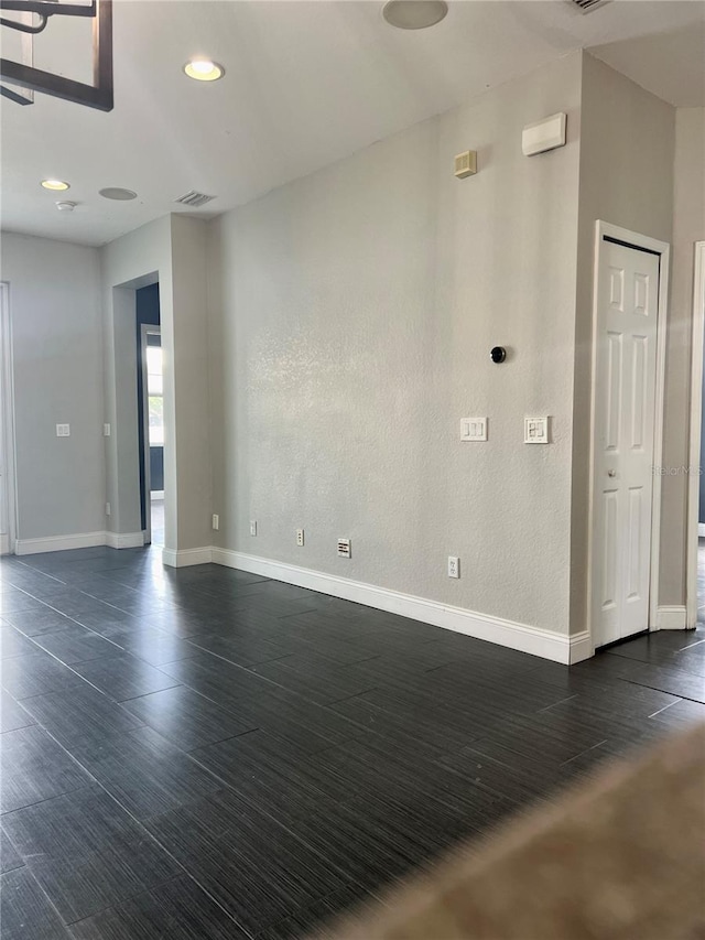 spare room with dark hardwood / wood-style flooring