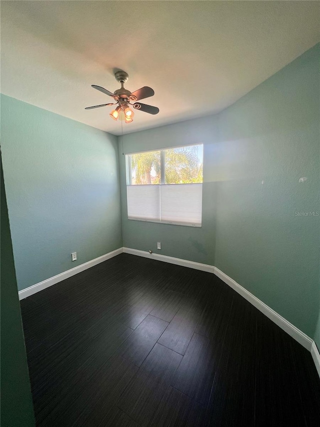 unfurnished room featuring ceiling fan and dark hardwood / wood-style flooring