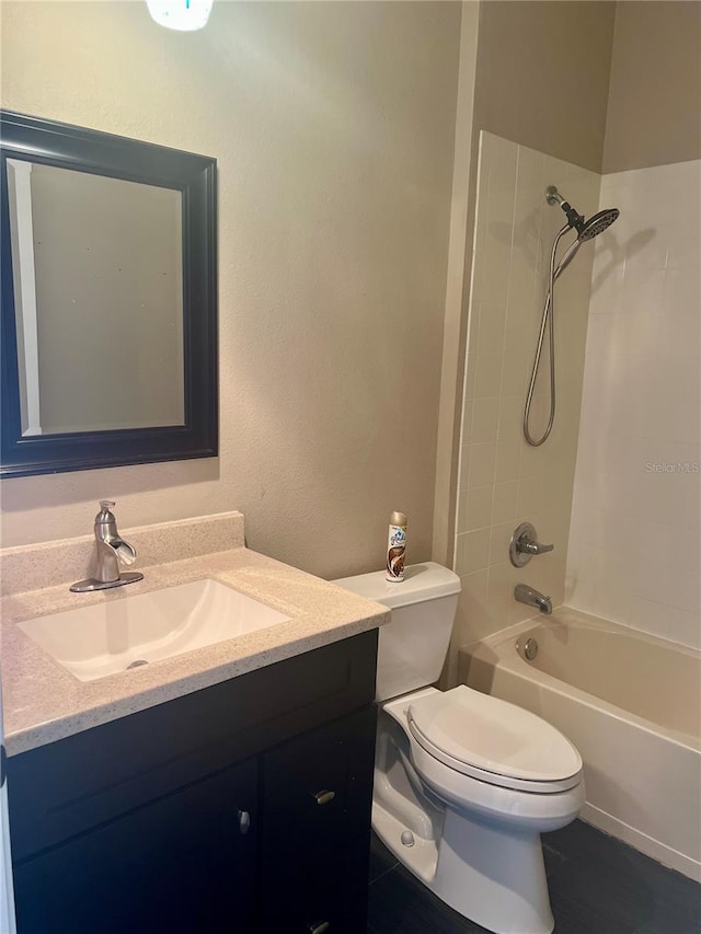 full bathroom featuring toilet, tiled shower / bath combo, and oversized vanity