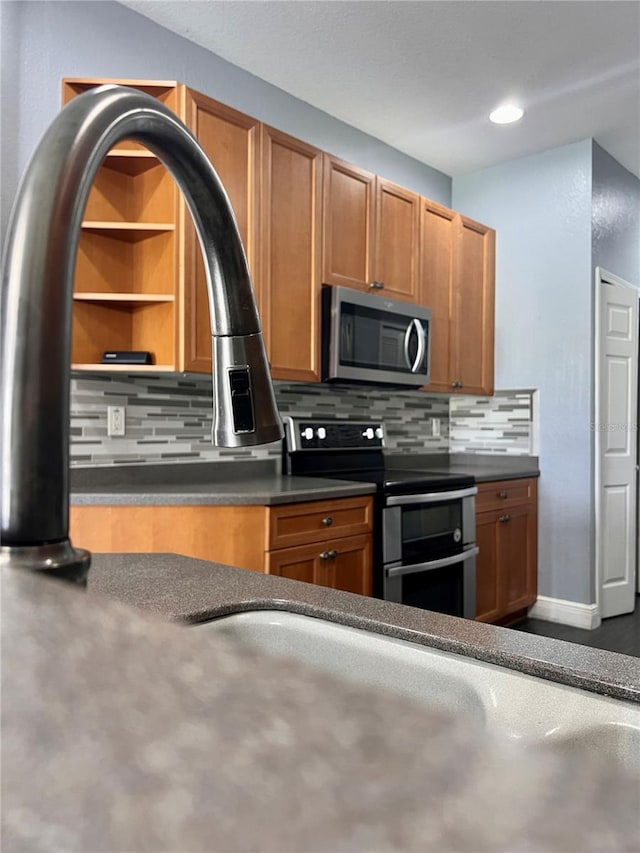 kitchen featuring backsplash and electric range