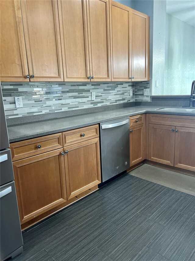 kitchen with backsplash, stainless steel dishwasher, and sink