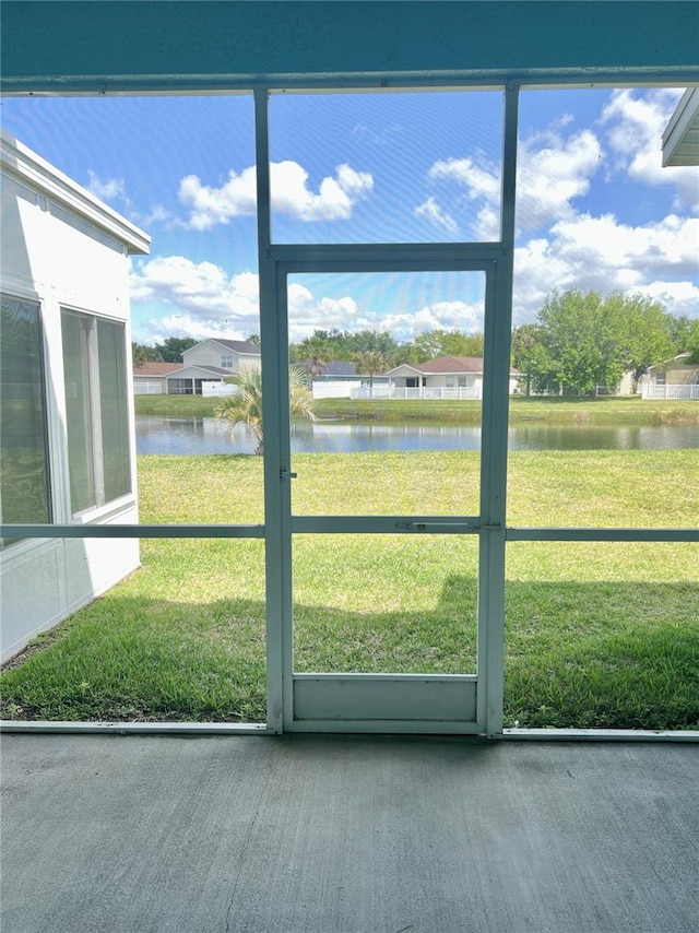 unfurnished sunroom with a water view