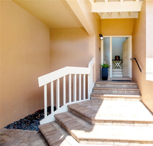 view of exterior entry featuring stucco siding