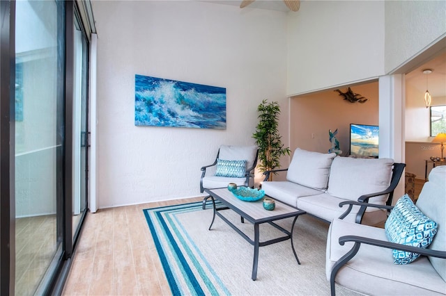 living room featuring light wood-type flooring and ceiling fan