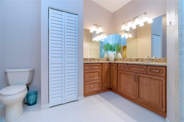 full bath featuring a closet, vanity, and toilet