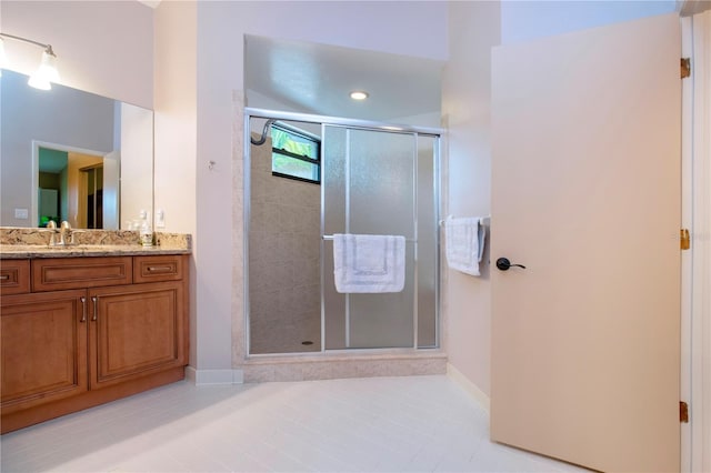 full bath with a shower stall, baseboards, and vanity