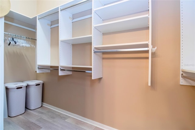 walk in closet featuring light wood finished floors