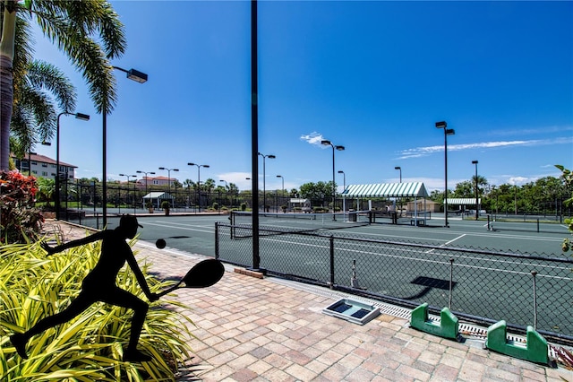 view of tennis court featuring fence