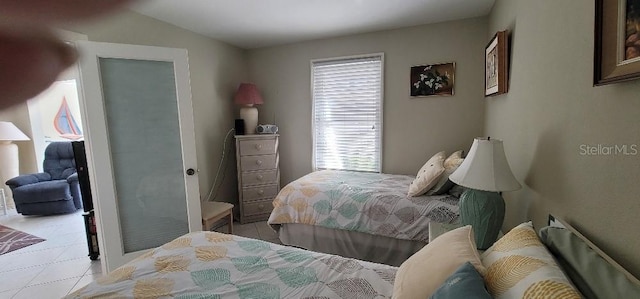 tiled bedroom featuring lofted ceiling