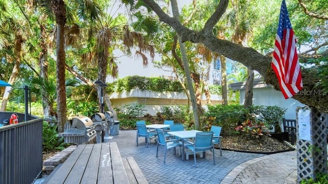 wooden deck featuring grilling area and a patio