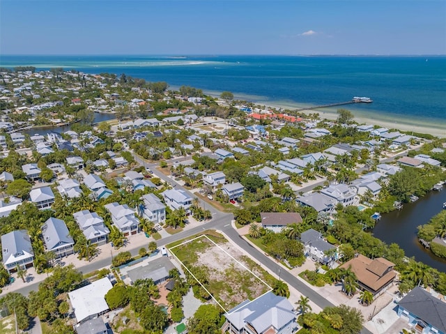 birds eye view of property featuring a view of the beach and a water view