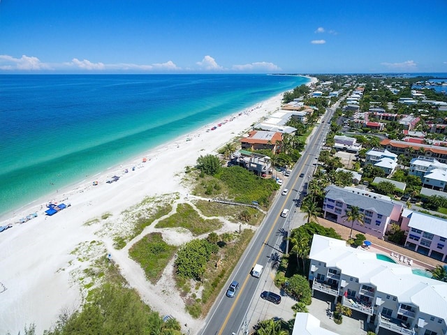 birds eye view of property with a water view and a view of the beach