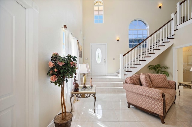 tiled foyer featuring a high ceiling and a wealth of natural light