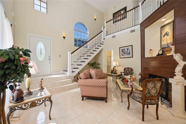 entrance foyer with light tile floors and a high ceiling