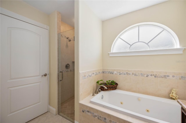 bathroom featuring tile floors and separate shower and tub