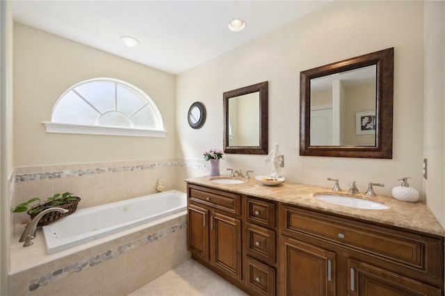 bathroom featuring tiled tub, tile floors, dual sinks, and vanity with extensive cabinet space