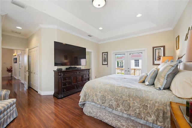 bedroom featuring french doors, ornamental molding, a raised ceiling, access to outside, and dark hardwood / wood-style floors