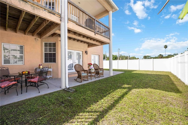 view of yard with a balcony and a patio