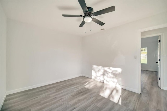 unfurnished room featuring light hardwood / wood-style flooring and ceiling fan